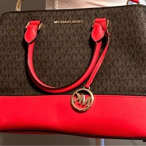 Michael Kors red and brown three pocket bag.